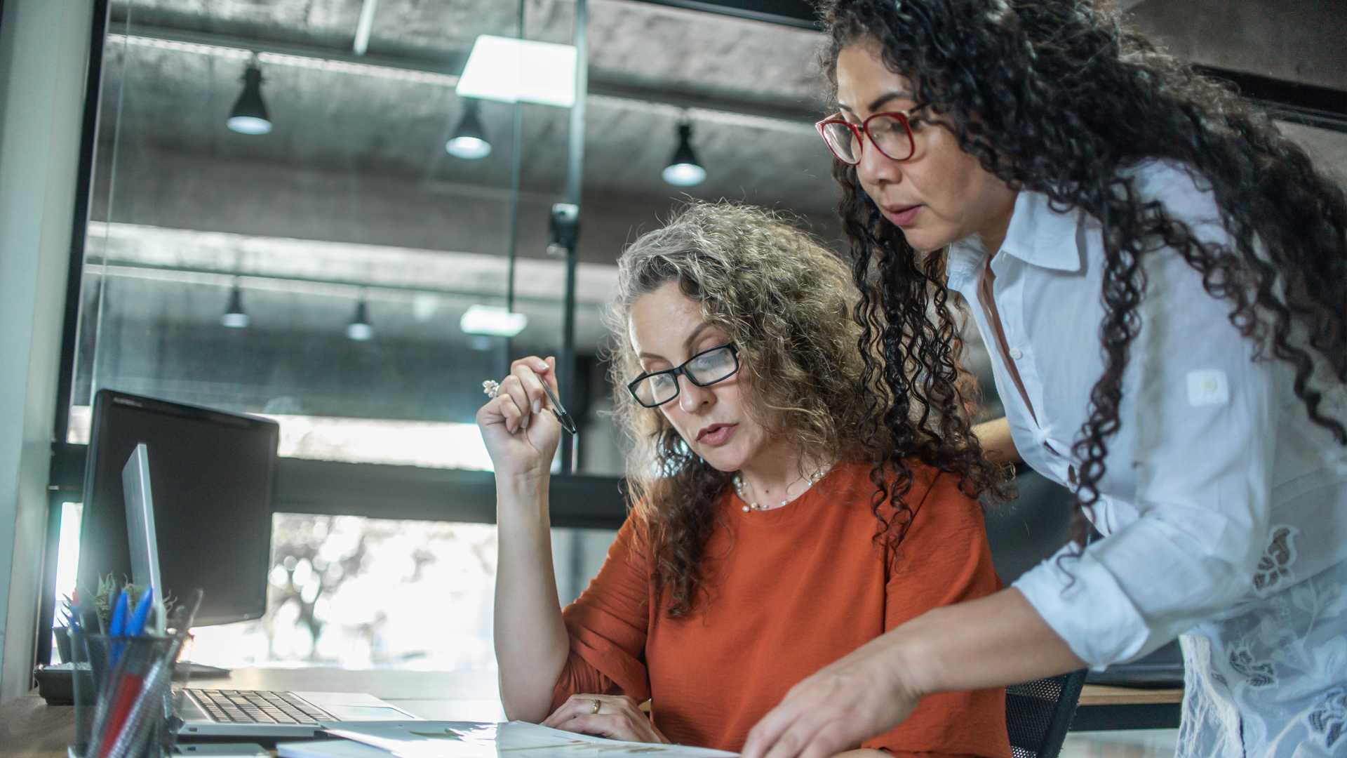Two women looking over documents together.
